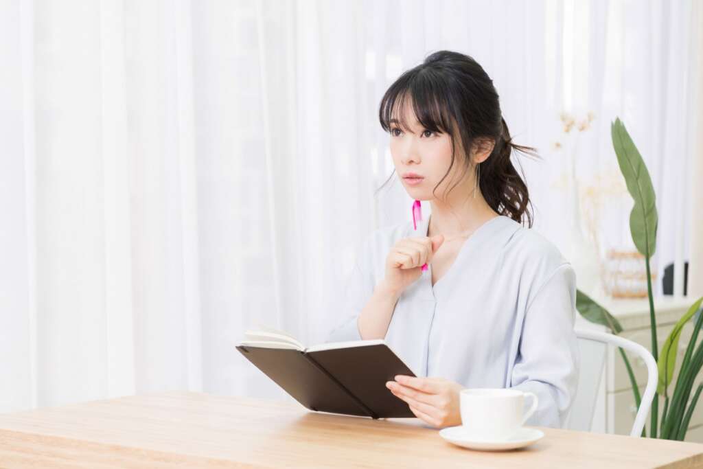 ノートにまとめる女性
